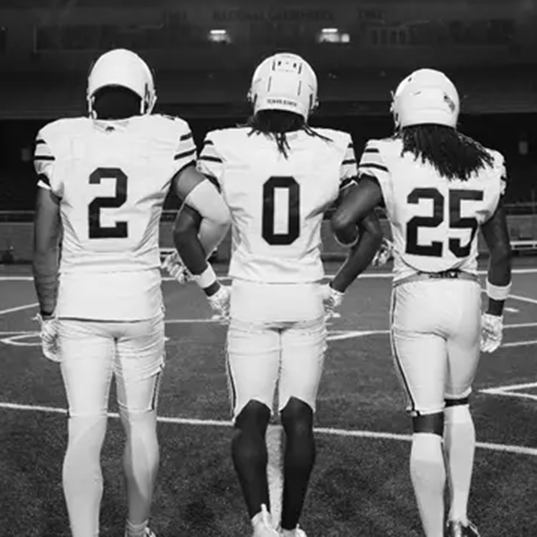Three football players with jersey numbers 2, 0, and 25
