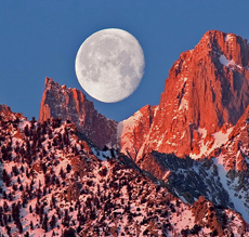view of moon through two mountain ridges