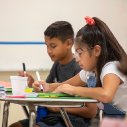 two young Hispanic children in classroom setting