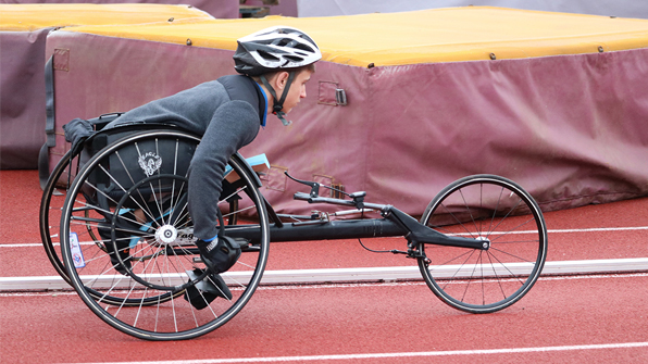 athlete in wheelchair on racetrack