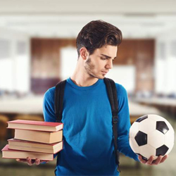 man holding stack of books and a soccer ball