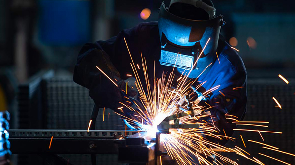 sparks flying as person welds metal